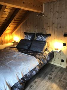 a large bed in a room with wooden walls at Chalet Colenfrey - Chalets pour 10 Personnes 14 in Valloire