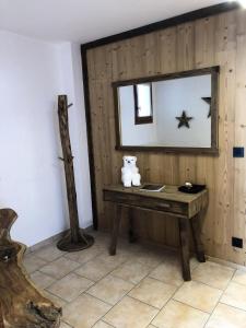 a room with a wooden table and a mirror at Chalet Colenfrey - Chalets pour 10 Personnes 14 in Valloire