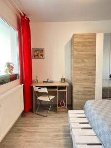 a bedroom with a desk and a bed and a window at 3 rooms apartment Airy & Bright Palas Style in Iaşi