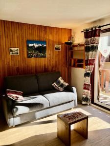 ein Wohnzimmer mit einem Sofa und einem Tisch in der Unterkunft Résidence Carene - 2 Pièces pour 4 Personnes 74 in Valloire