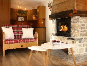 a living room with a couch and a fireplace at Résidence Les Fermes Du Planet - 4 Pièces pour 8 Personnes 94 in Valloire