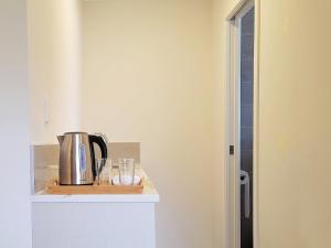a kitchen with a coffee pot on a counter at Bay Villa with 5 Bedrooms and 5 Bathrooms in Whangaparaoa