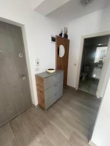 a bathroom with a dresser and a mirror at Luxury Apartment in Piteşti
