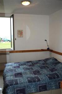 Schlafzimmer mit einem Bett und einem Fenster in der Unterkunft Résidence Palmyra - 2 Pièces pour 4 Personnes 414 in Le Barcarès