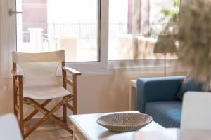 a living room with a chair and a blue couch at Andreas House in Lixouri