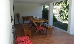 a patio with a wooden table and chairs at Casa Do Fiscal in Barroselas