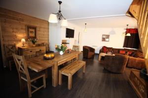a living room with a wooden table and a couch at Les Chalets D'adrien - Pièces 64 in Valloire