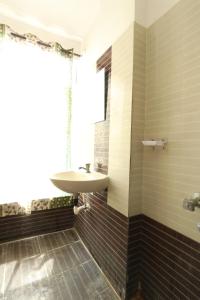 a bathroom with a sink and a window at ON GREEN RESIDENCY in Secunderabad