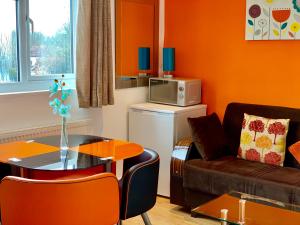 a small living room with a table and a couch at 1 Bedroom Apartment, Reception ,Kitchenette, Private Bathroom in Ilford +46 photos