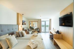 a large living room with a couch and a television at HL Rondo Hotel in Playa del Ingles