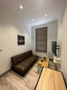 a living room with a couch and a coffee table at Stylish and cozy flats in London