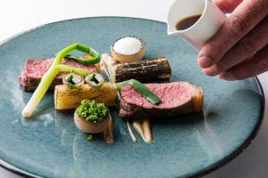 a plate of food with meat and cheese and a cup of coffee at Hazel Bank Country House Borrowdale Valley in Rosthwaite