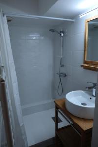a white bathroom with a sink and a shower at Chalet Du Regain - 3 Pièces pour 8 Personnes 94 in Valloire