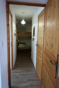 a hallway with a door and a room with a bed at Chalet Du Regain - 3 Pièces pour 8 Personnes 94 in Valloire