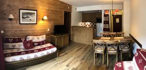 a living room with a couch and a dining room at Les Chalets Valoria - 3 Pièces pour 6 Personnes 54 in Valloire