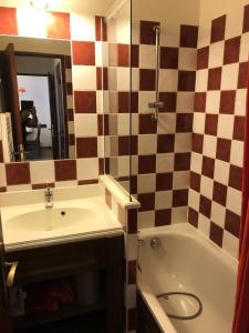 a bathroom with a sink and a tub and a mirror at Les Chalets Valoria - 3 Pièces pour 6 Personnes 54 in Valloire