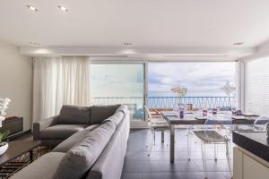 a living room with a couch and a table at 2 bedrooms Duplex penthouse - Monaco border in Roquebrune-Cap-Martin