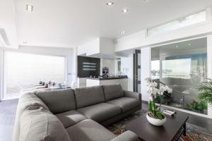 a living room with a couch and a kitchen at 2 bedrooms Duplex penthouse - Monaco border in Roquebrune-Cap-Martin