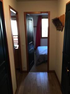 a room with a door and a bedroom with a bed at Chalets Du Galibier I - 2 Pièces pour 4 Personnes 74 in Valloire