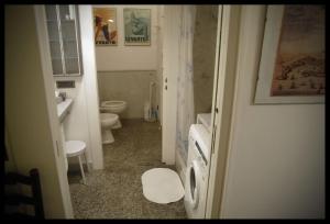 a small bathroom with a toilet and a sink at Rubino Apartment in Levanto