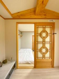 a room with a door with a bed in it at Hanok guesthouse Ann 