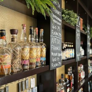 a display of bottles of alcohol on a shelf in a store at Hotell Gillet i Köping in Köping +15 photos