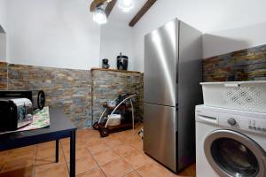 a kitchen with a refrigerator and a washing machine at La Planta Vieja in La Orotava