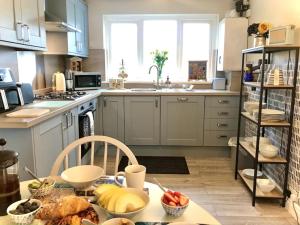 a kitchen with a table with food on it at Charming Coastal Getaway - Pembroke in Pembrokeshire