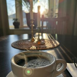 a cup of coffee sitting on top of a table at Hotell Gillet i Köping in Köping