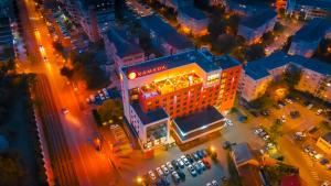 an overhead view of a building in a city at night at Ramada by Wyndham Oradea in Oradea