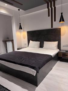 1 dormitorio con 1 cama grande y cabecero negro en womco butik otel, en Estambul