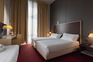 Postel nebo postele na pokoji v ubytování Art Hotel Olympic + 37 fotografií
