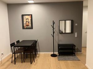 a dining room with a table and chairs and a mirror at Ku'damm cosy condo Berlin center in Berlin