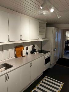 a kitchen with white cabinets and a sink at Cozy Holiday Apartment In Allinge in Allinge