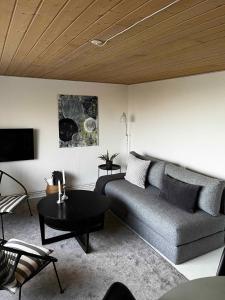 a living room with a couch and a table at Cozy Holiday Apartment In Allinge in Allinge