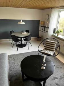 a living room with a table and chairs at Cozy Holiday Apartment In Allinge in Allinge