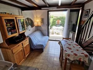 una pequeña sala de estar con mesa y silla en Résidence GRANDE BLEUE - Maisons & Villas pour 6 Personnes 294, en Port Leucate