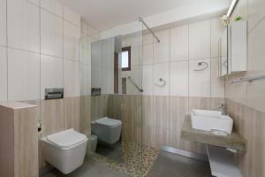 a bathroom with a toilet and a sink and a mirror at San Lameer Villa 10412 - 1 Bedroom Classic - 2 pax - San Lameer Rental Agency in Southbroom