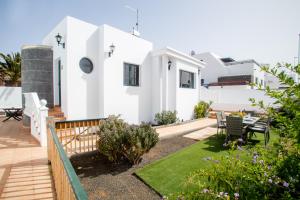 a view of a house with a garden at Sunny Golf Villas in Puerto del Carmen