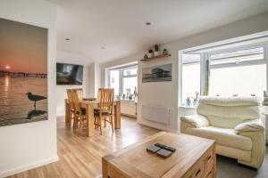 a living room with a couch and a table at Brighton & Hove Beach - group or family fun in Brighton & Hove