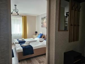 a bedroom with three beds and a mirror at Apartamenty Premium Biznes Rumia in Rumia