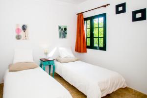 two beds in a room with a window at Sunny Golf Villas in Puerto del Carmen