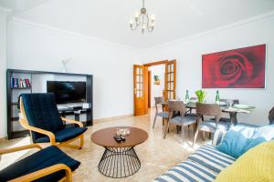 a living room with a couch and a table at Sunny Golf Villas in Puerto del Carmen