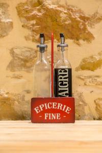 two glass bottles are sitting next to a red lighter at Hamac Suites - studio Ainay 1 - hyper centre Lyon in Lyon