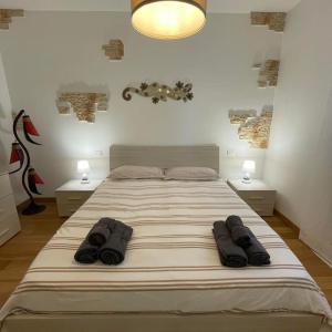 a large bed in a bedroom with two night stands at Sereno house apartment in Brescia