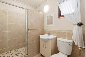 a bathroom with a toilet and a shower and a sink at San Lameer Villa 10415 - 2 Bedroom Classic - 4 pax - San Lameer Rental Agency in Southbroom +28 photos