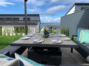 a wooden table with wine glasses on a patio at 4 Bed in Appledore 92017 in Appledore
