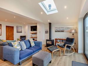 a living room with a blue couch and a fire place at 2 Bed in Seasalter WCC05 in Seasalter