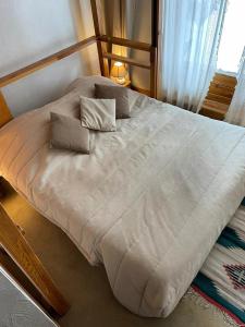 a large white bed with two pillows on it at Résidence Praz De La Legettaz - 4 Pièces pour 6 Personnes 574 in Val-d'Isère