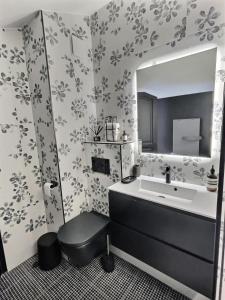 a bathroom with a sink and a mirror at Chalet Du Jardin Alpin Ii - 3 Pièces pour 4 Personnes 794 in Val-d'Isère